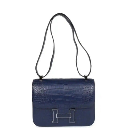 Blue alligator-effect crossbody handbag with long strap and front flap H clasp