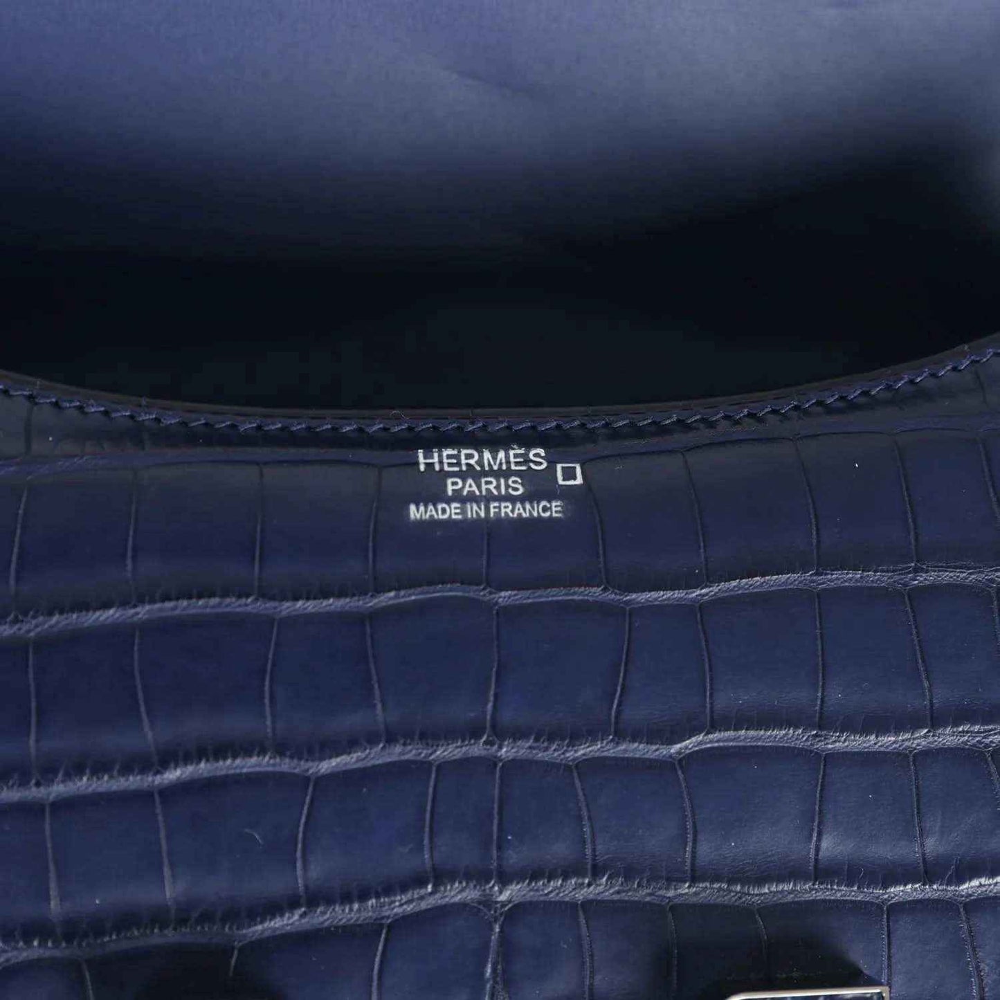 Hermès Paris Made in France stamp on blue croc-embossed handbag interior