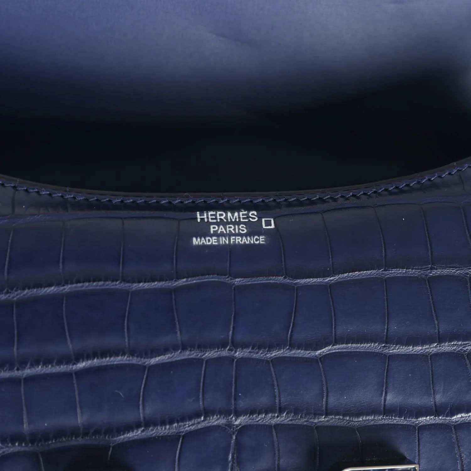 Hermès Paris Made in France stamp on blue croc-embossed handbag interior