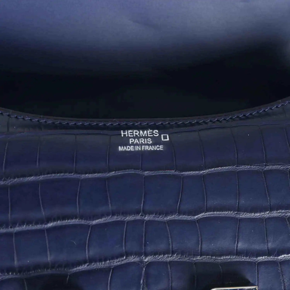 Hermès Paris Made in France stamp on blue croc-embossed handbag interior