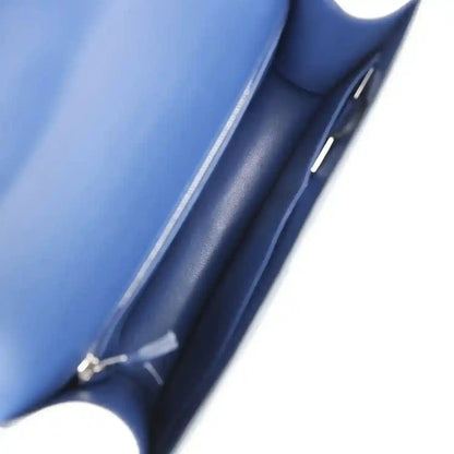 Blue leather-lined handbag interior with side seam and strap hardware