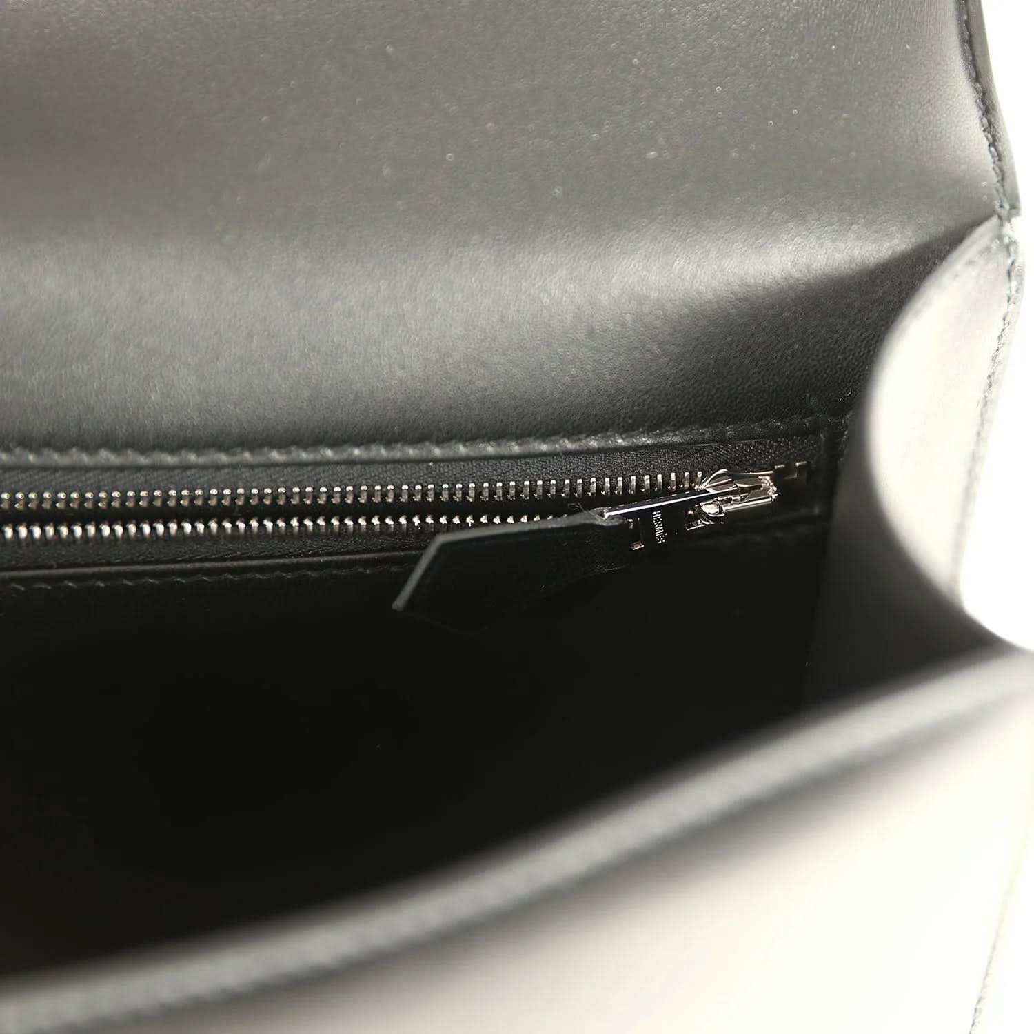 Black leather bag interior with metal zipper and stitched seam