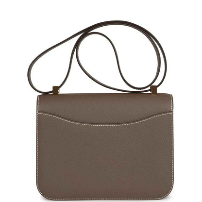 Taupe leather mini shoulder bag with flap, double straps, and stitched trim