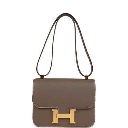 Taupe leather shoulder bag with gold H clasp on front flap and two shoulder straps