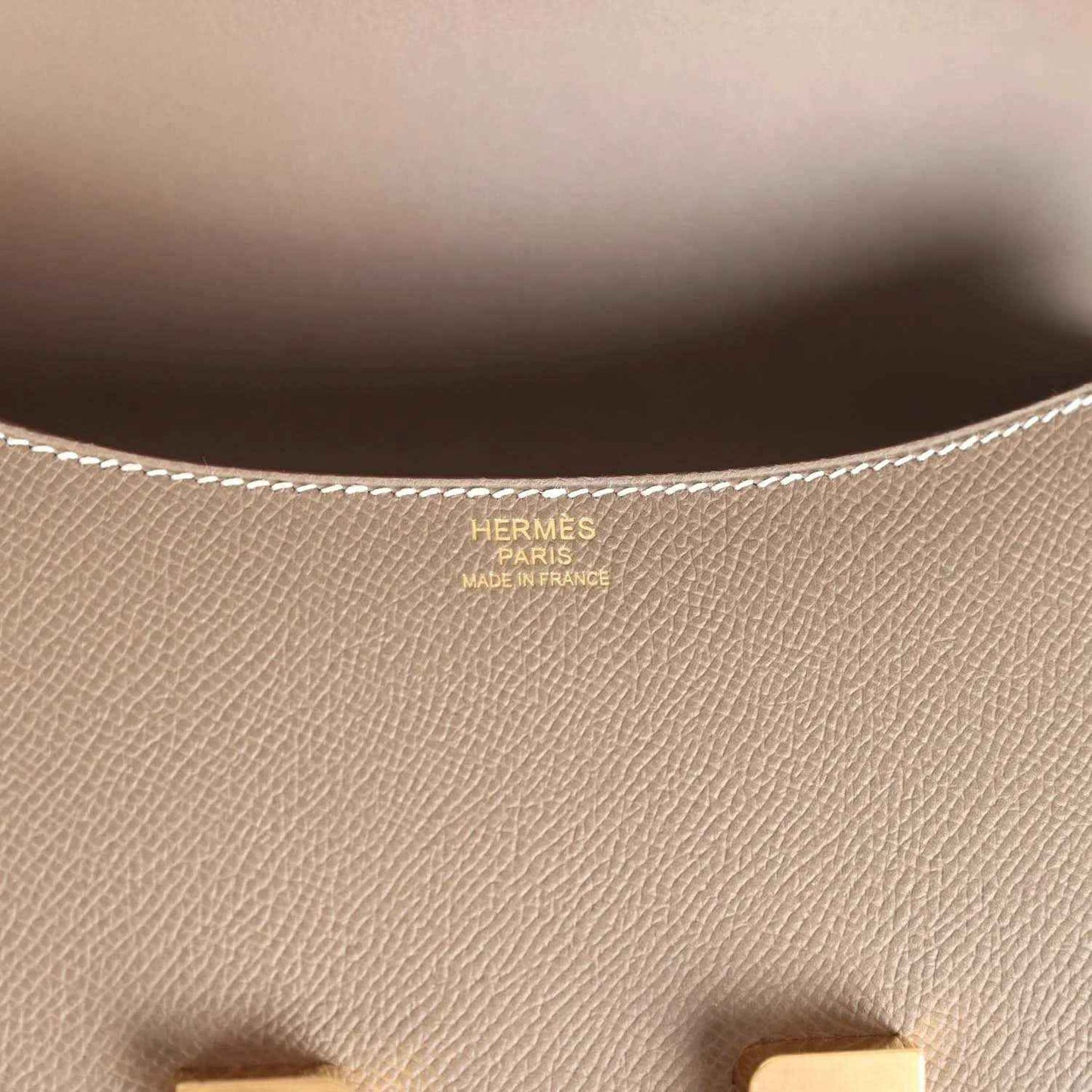 Leather interior close-up with Hermes Paris stamp and fine textured grain