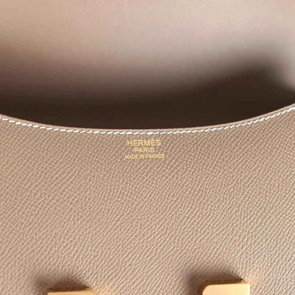 Leather interior close-up with Hermes Paris stamp and fine textured grain