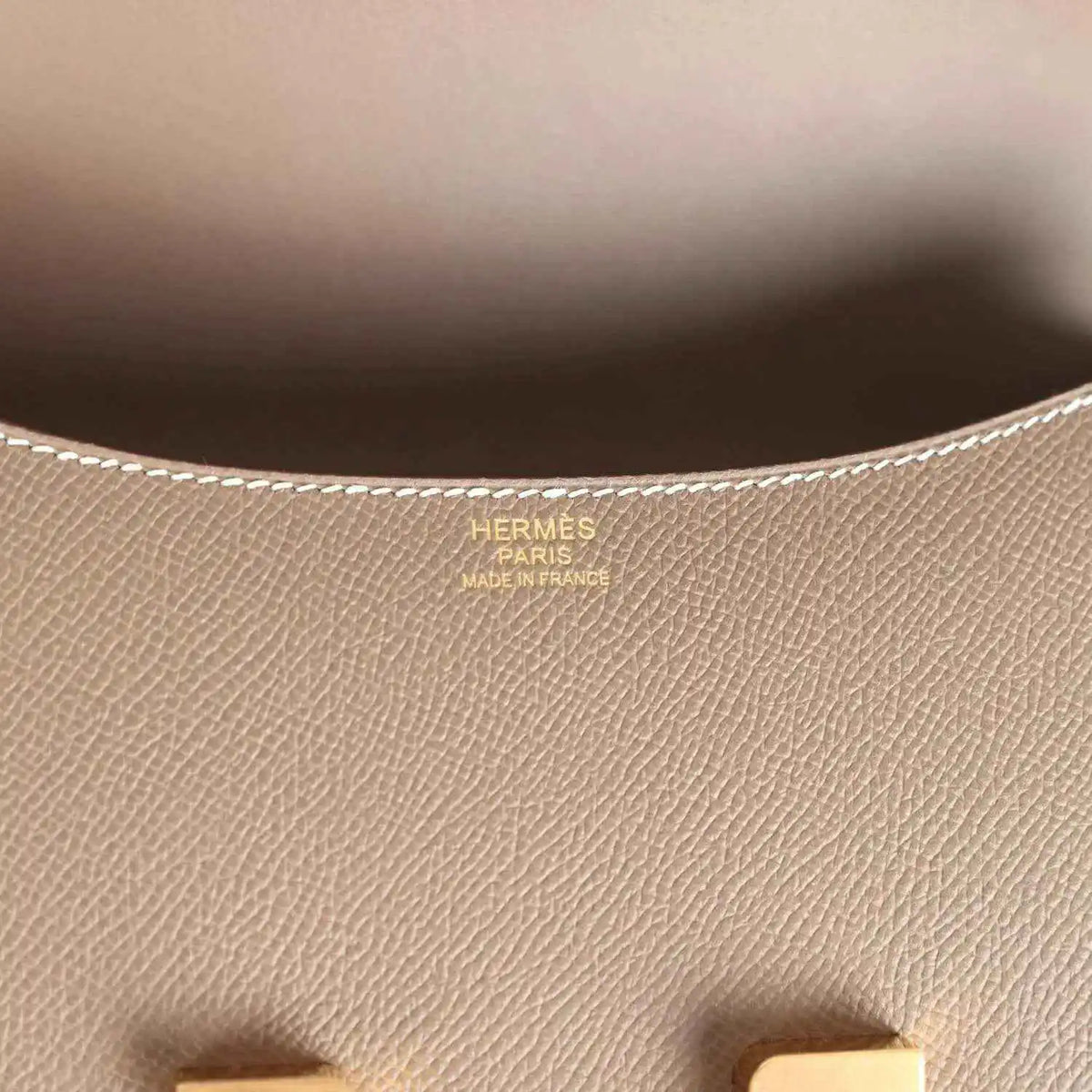 Leather interior close-up with Hermes Paris stamp and fine textured grain