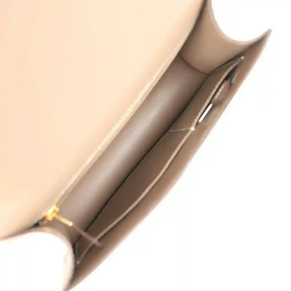 Taupe leather interior view with side compartment and stitching details