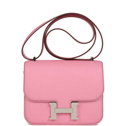 Pink leather crossbody bag with flap, H clasp, and top handle strap