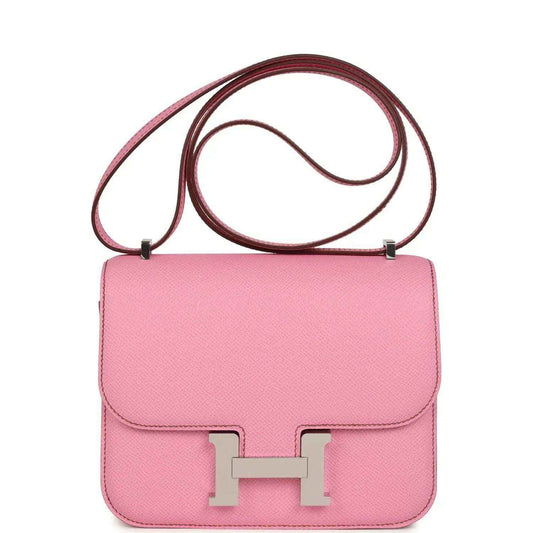 Pink leather crossbody bag with flap, H clasp, and top handle strap