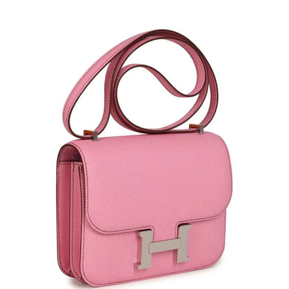 Pink leather shoulder bag with front flap, H clasp, and side handle strap