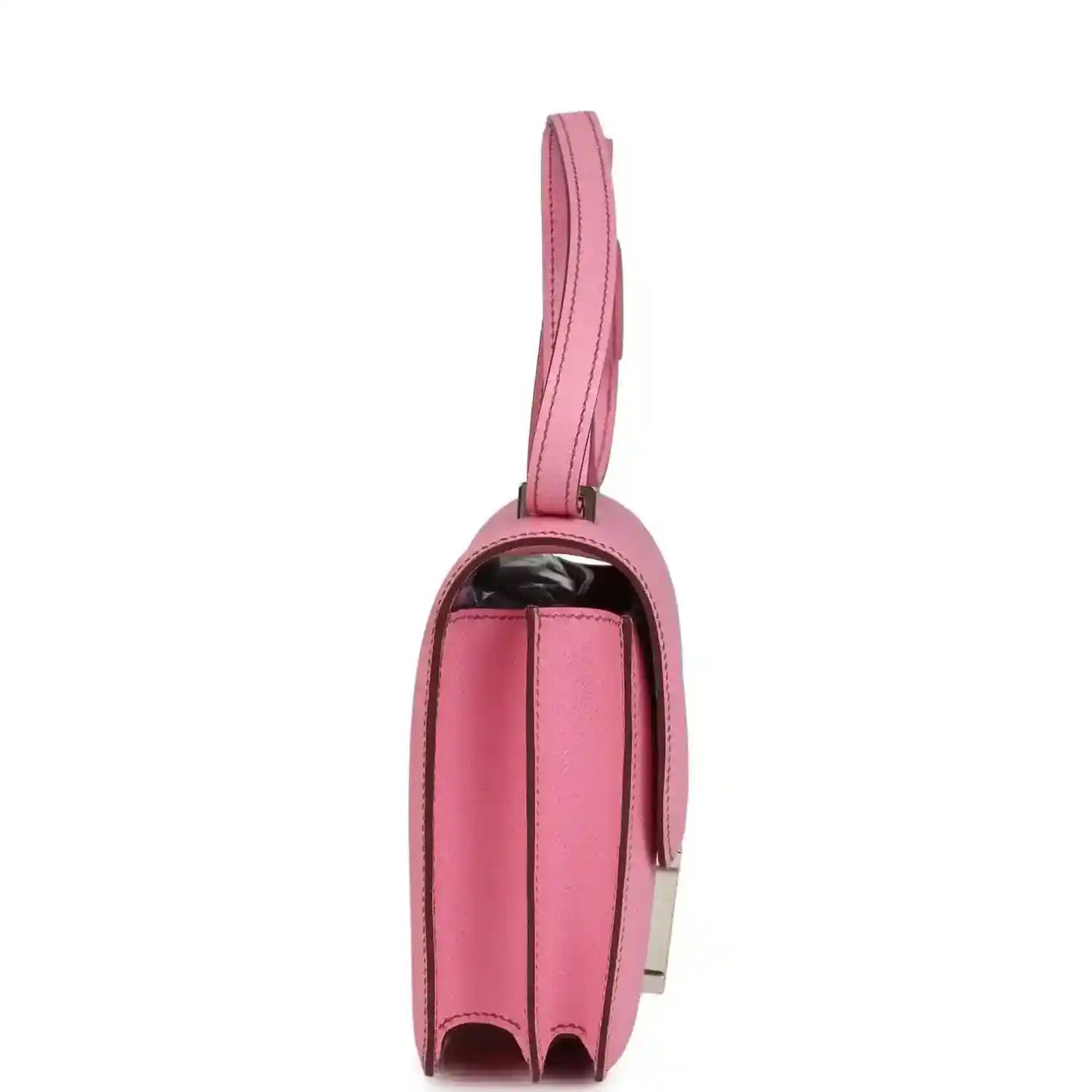 Pink leather mini bag with top handle strap and curved side profile