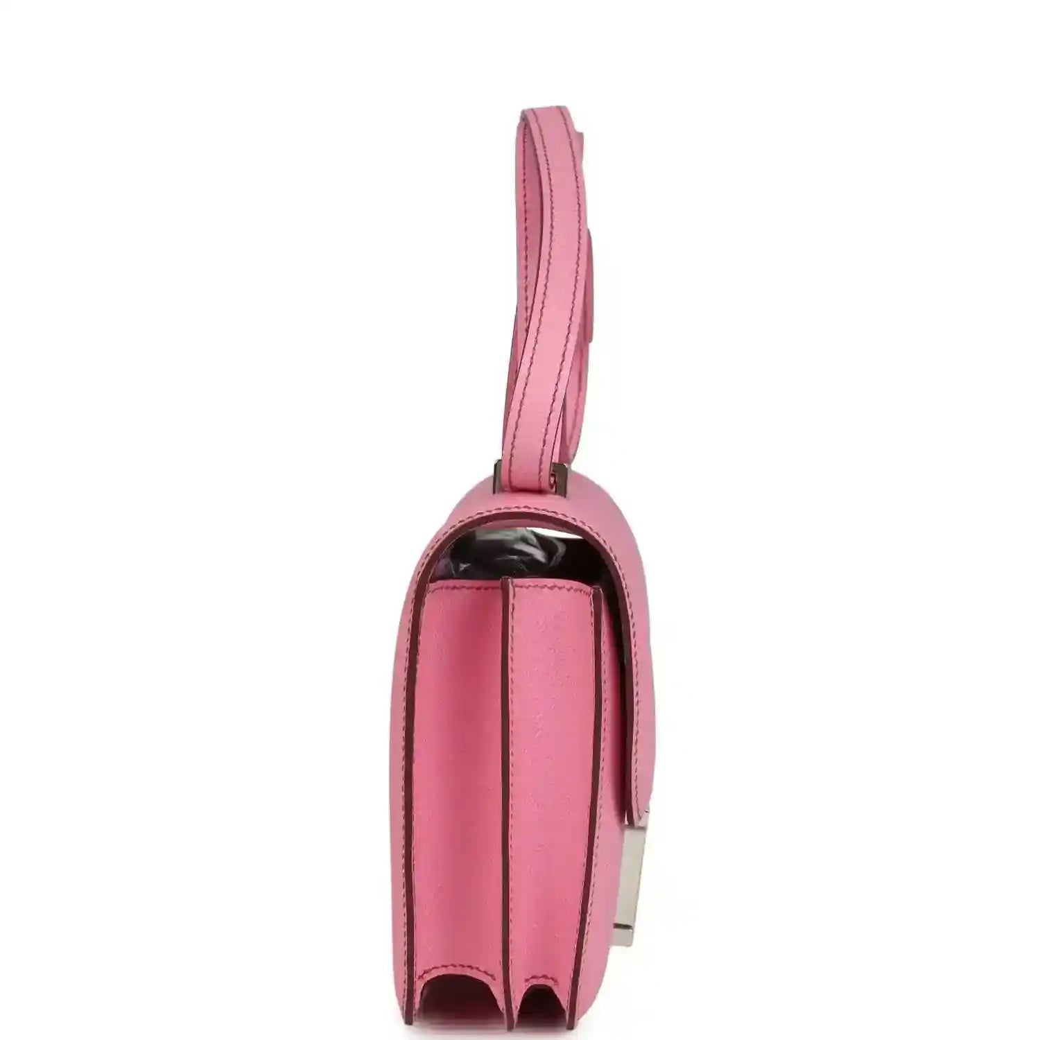 Pink leather mini bag with top handle strap and curved side profile