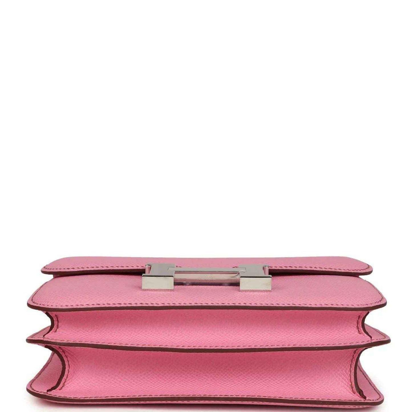 Pink leather bag underside view with H clasp hardware and open edge