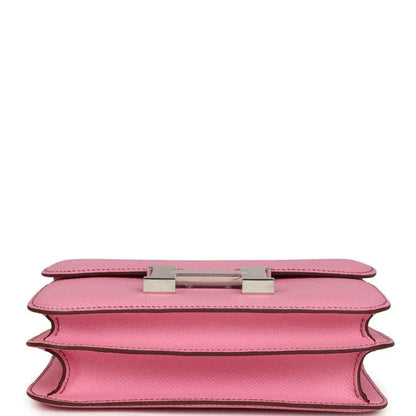 Pink leather bag underside view with H clasp hardware and open edge