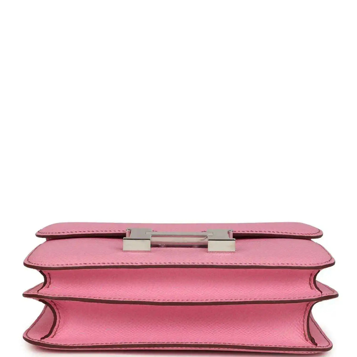 Pink leather bag underside view with H clasp hardware and open edge