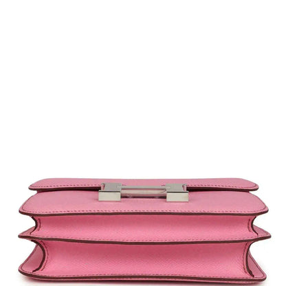 Pink leather bag underside view with H clasp hardware and open edge