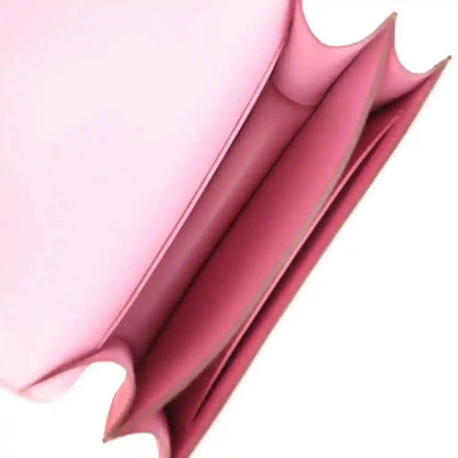Pink leather interior view with stitched side panels and open top edge