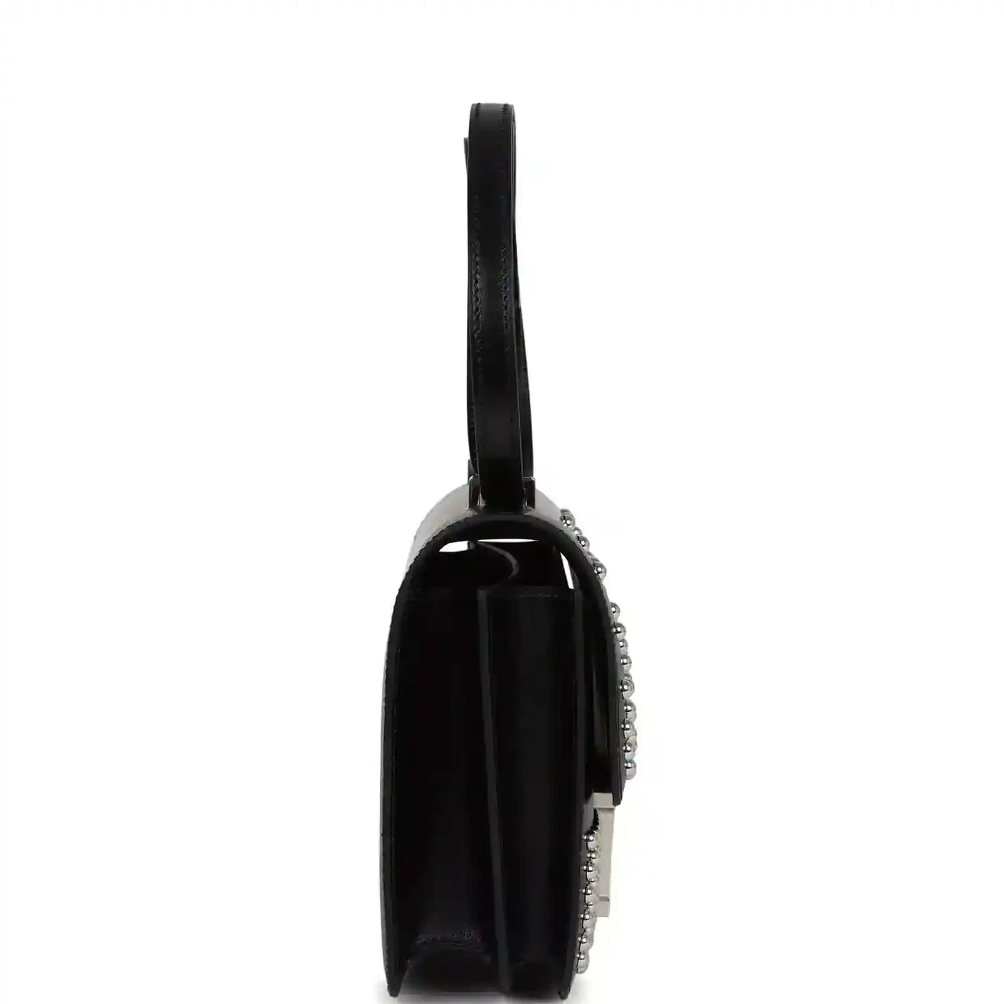 Black leather flap bag from side view with studded trim and top handle