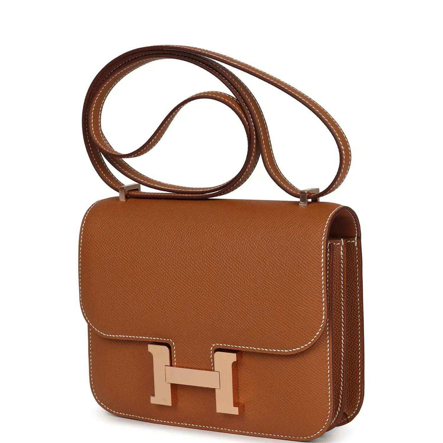 Brown leather mini handbag with top handle, side stitching, and front H clasp
