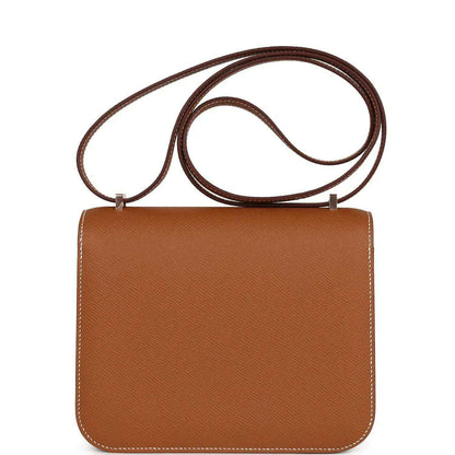 Brown leather mini handbag back with top handle strap and curved flap