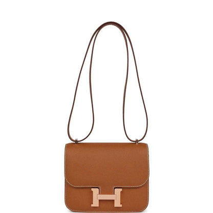 Brown leather mini handbag with shoulder strap and front flap H clasp