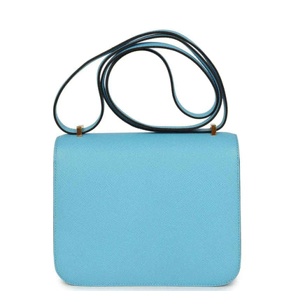 Mini crossbody bag in light blue leather with top strap and front flap