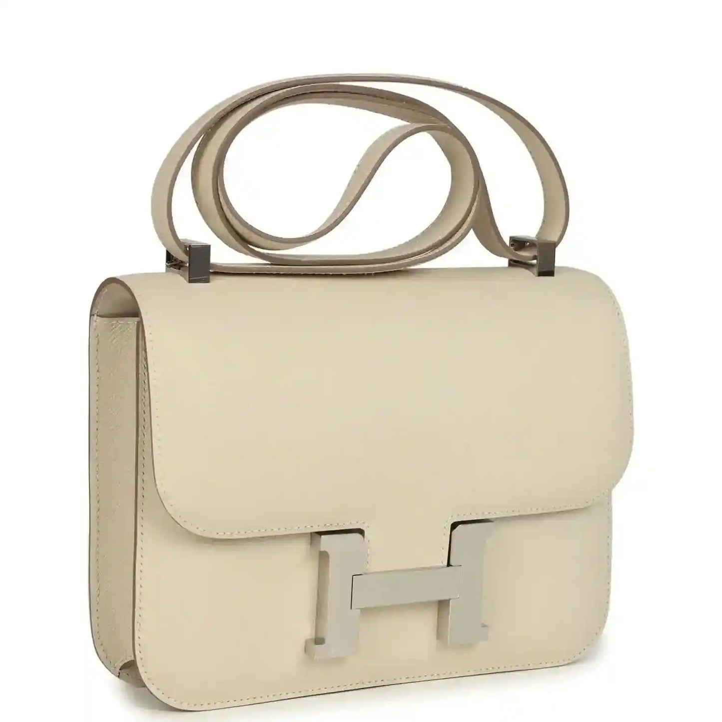 Beige leather handbag with front flap and light silver turn-lock clasp, top handle