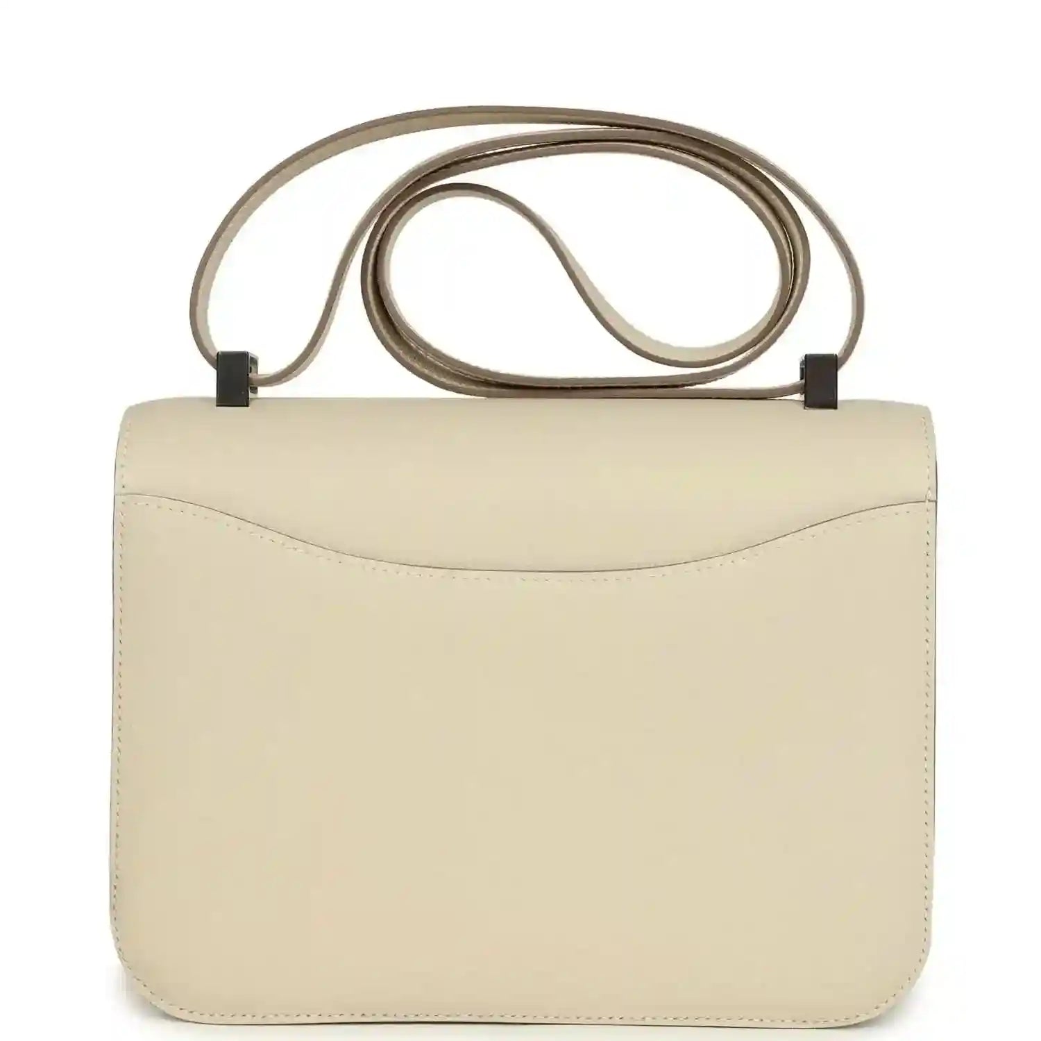 Beige leather handbag front view with curved flap and light silver clasp, top handle