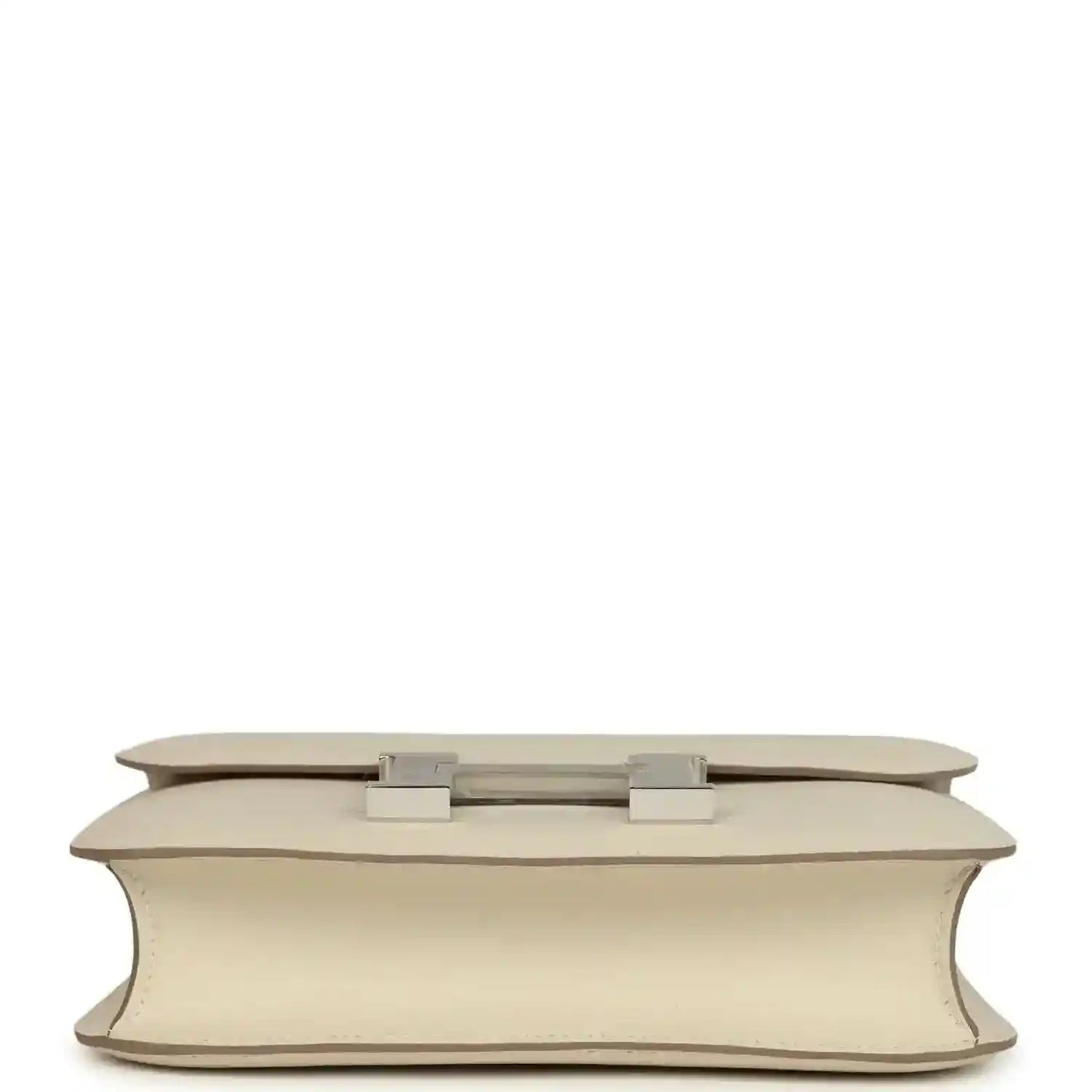 Beige leather handbag base view with two light silver feet and flap hardware