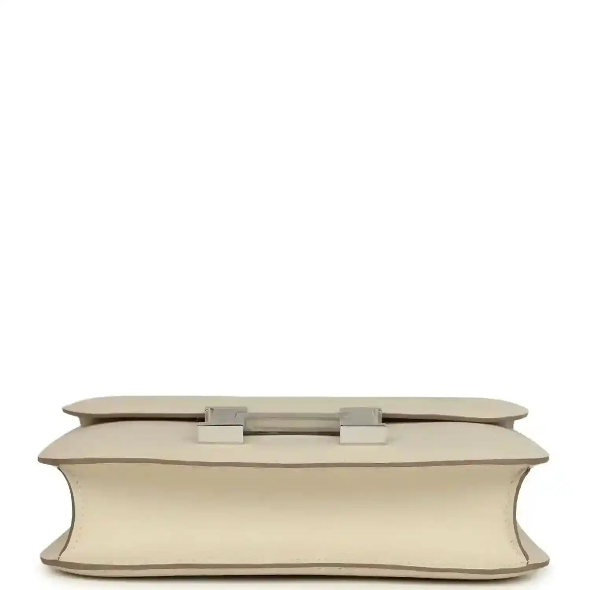 Beige leather handbag base view with two light silver feet and flap hardware