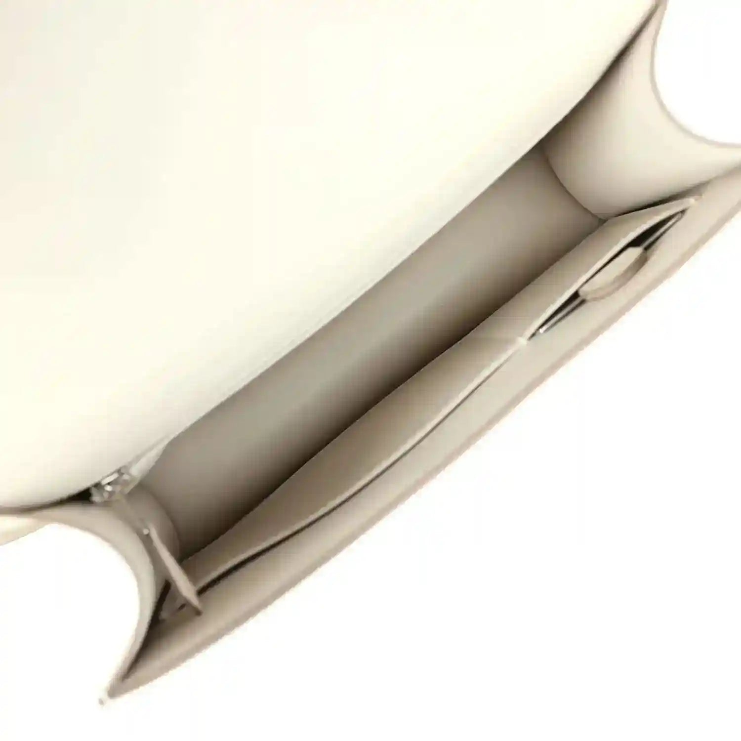 Beige leather handbag interior view with open lining and inner seam detail