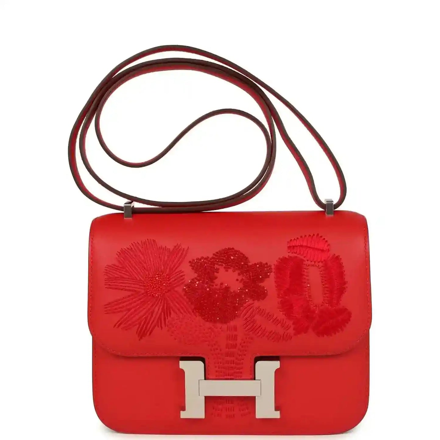 Red leather shoulder bag with floral embossed flap and silver H clasp, with double strap