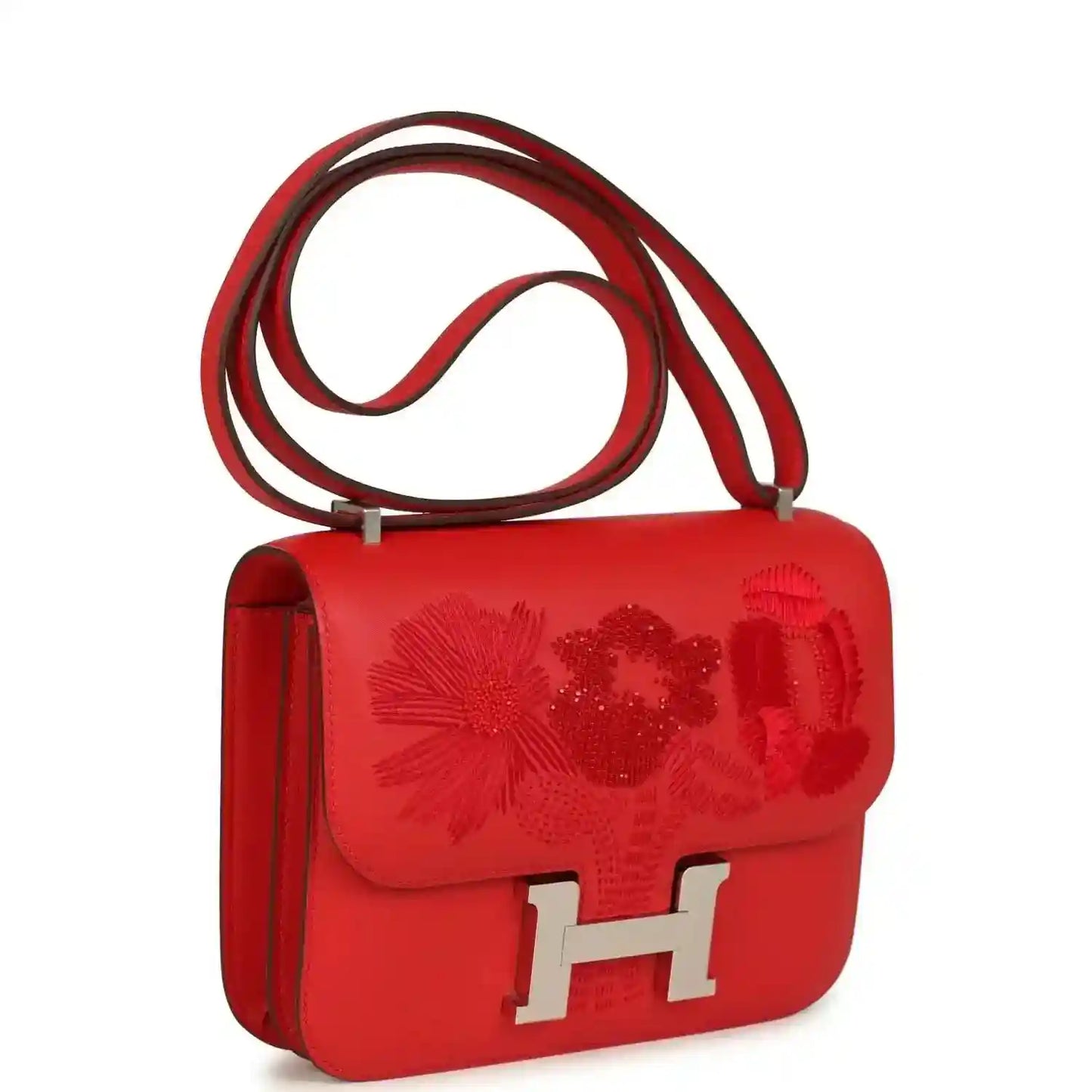 Red leather shoulder bag with embossed floral pattern, silver H clasp, and single side panel