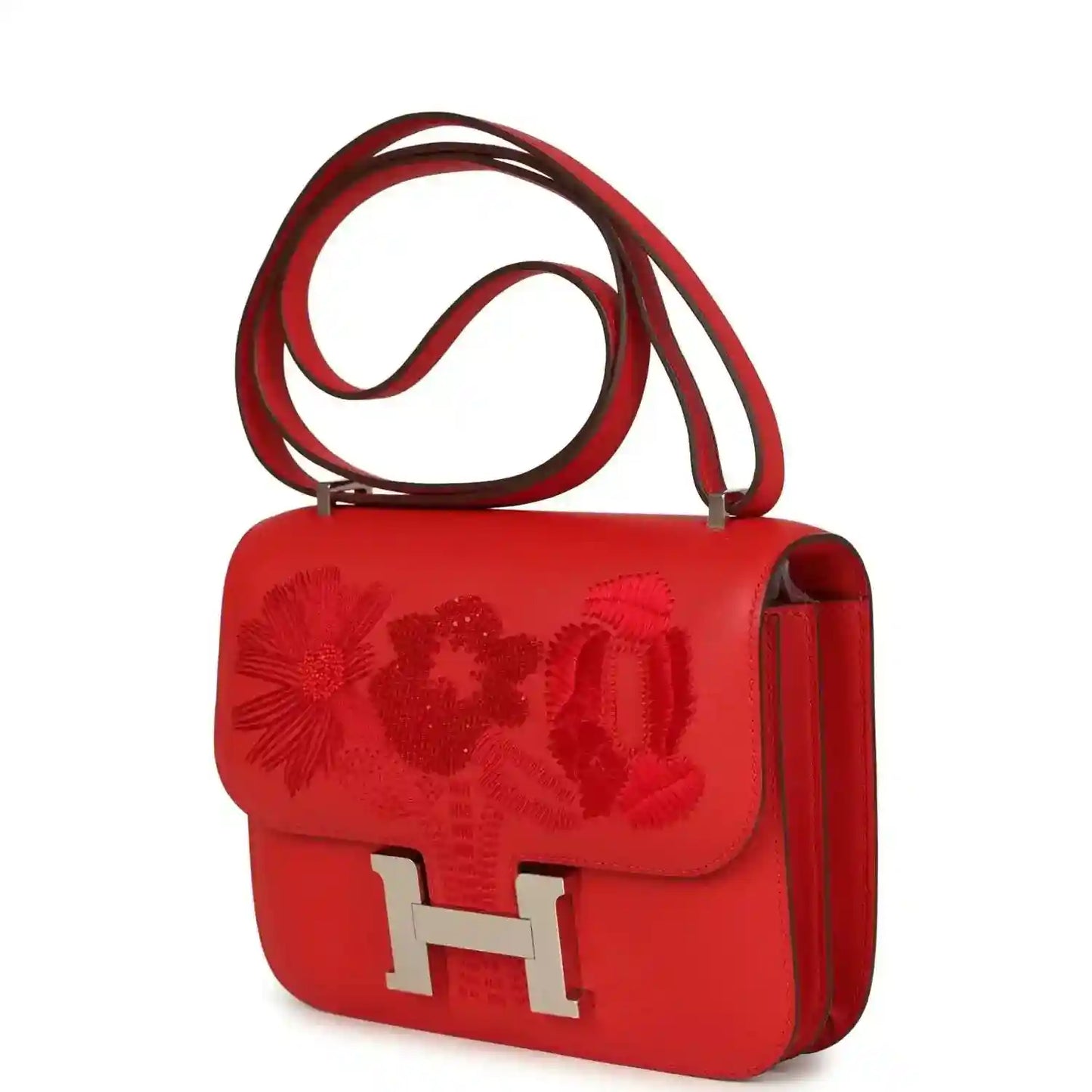 Red leather shoulder bag with embossed floral flap and silver H clasp, side profile