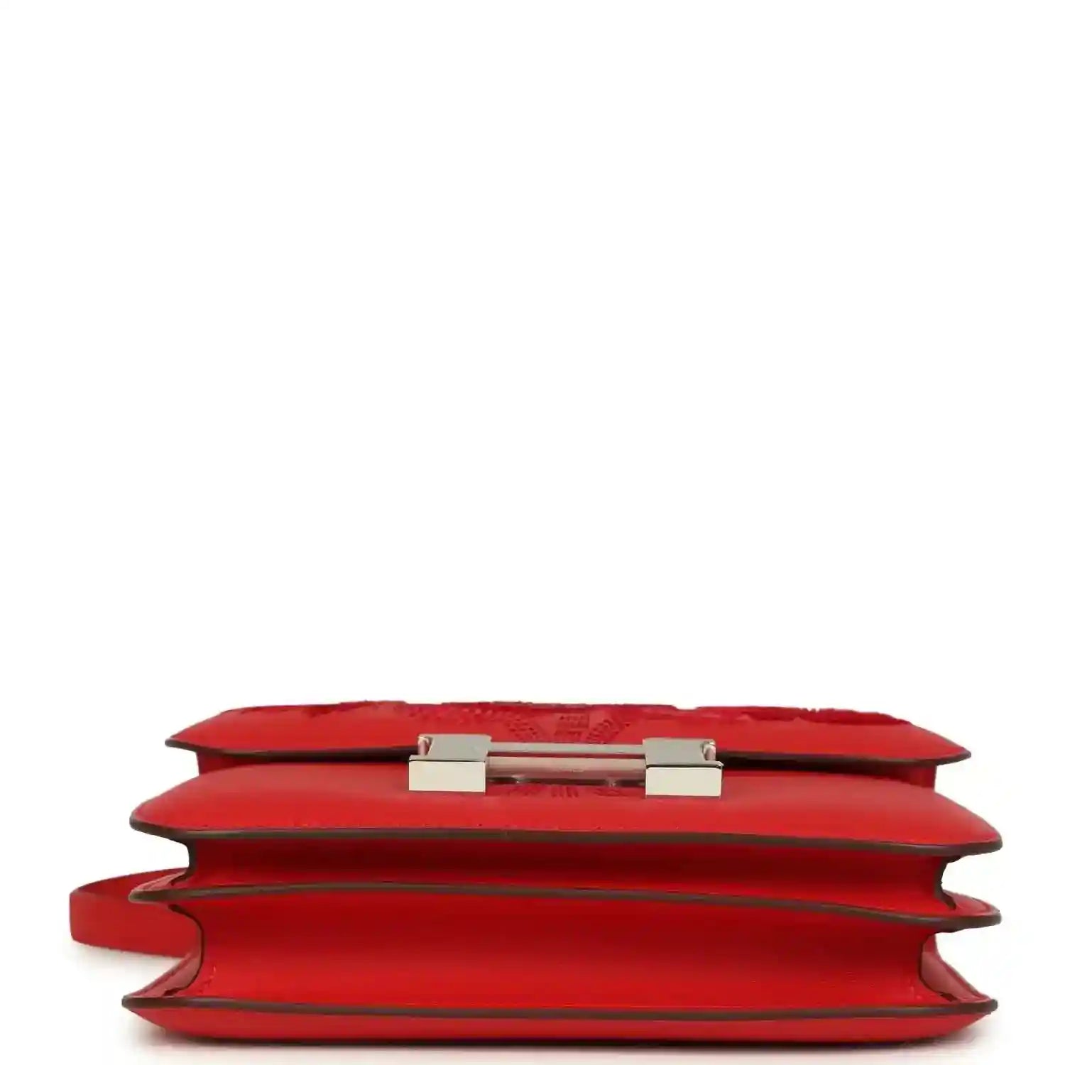 Red leather bag side profile with visible hinge hardware on the flap