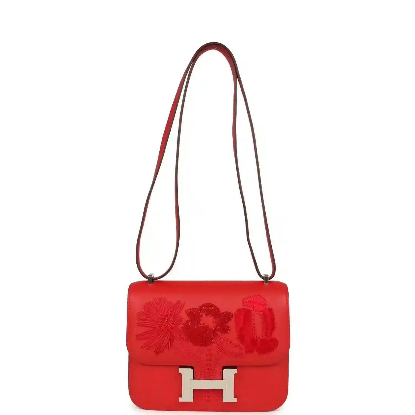 Red leather shoulder bag with embossed floral flap and silver H clasp, long strap