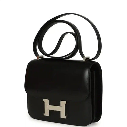 Black calfskin shoulder bag with front flap, H clasp, and side handle.