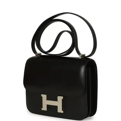 Black calfskin shoulder bag with front flap, H clasp, and side handle.