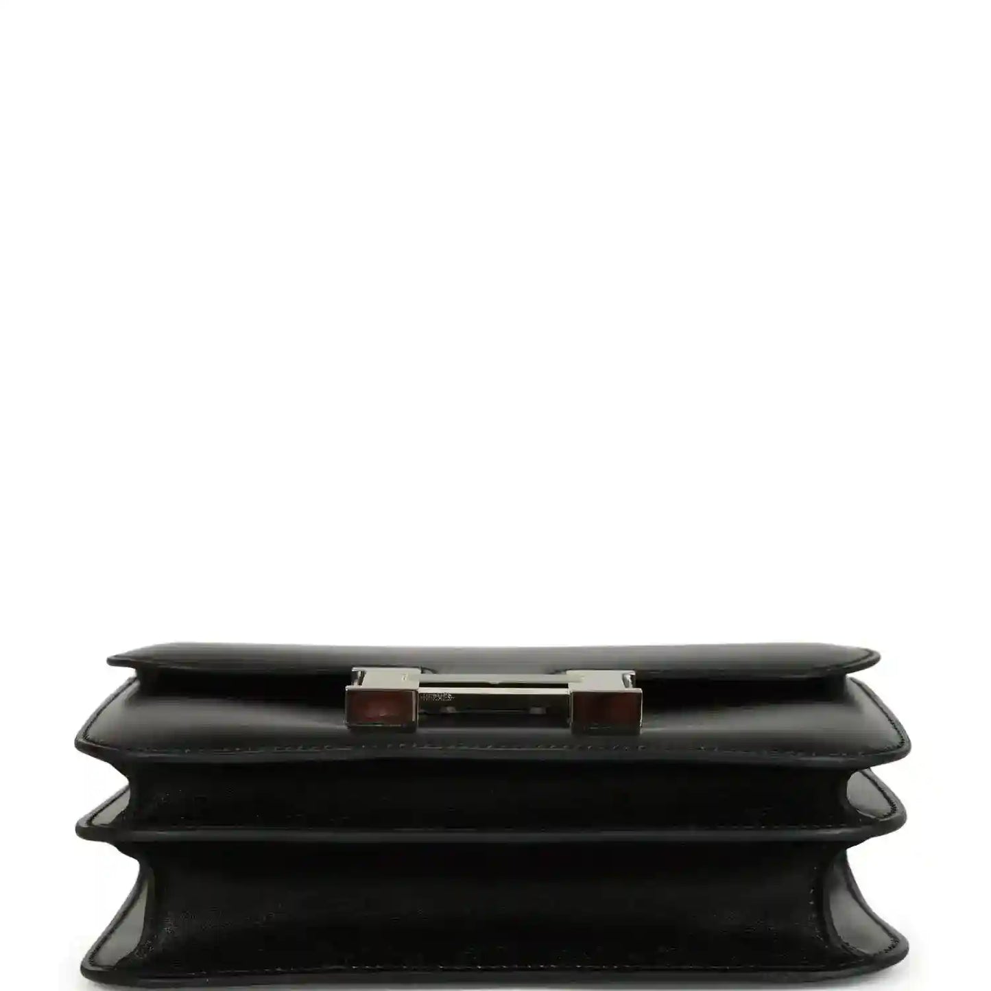 Black calfskin bag base view with layered feet and top edge hardware accents.