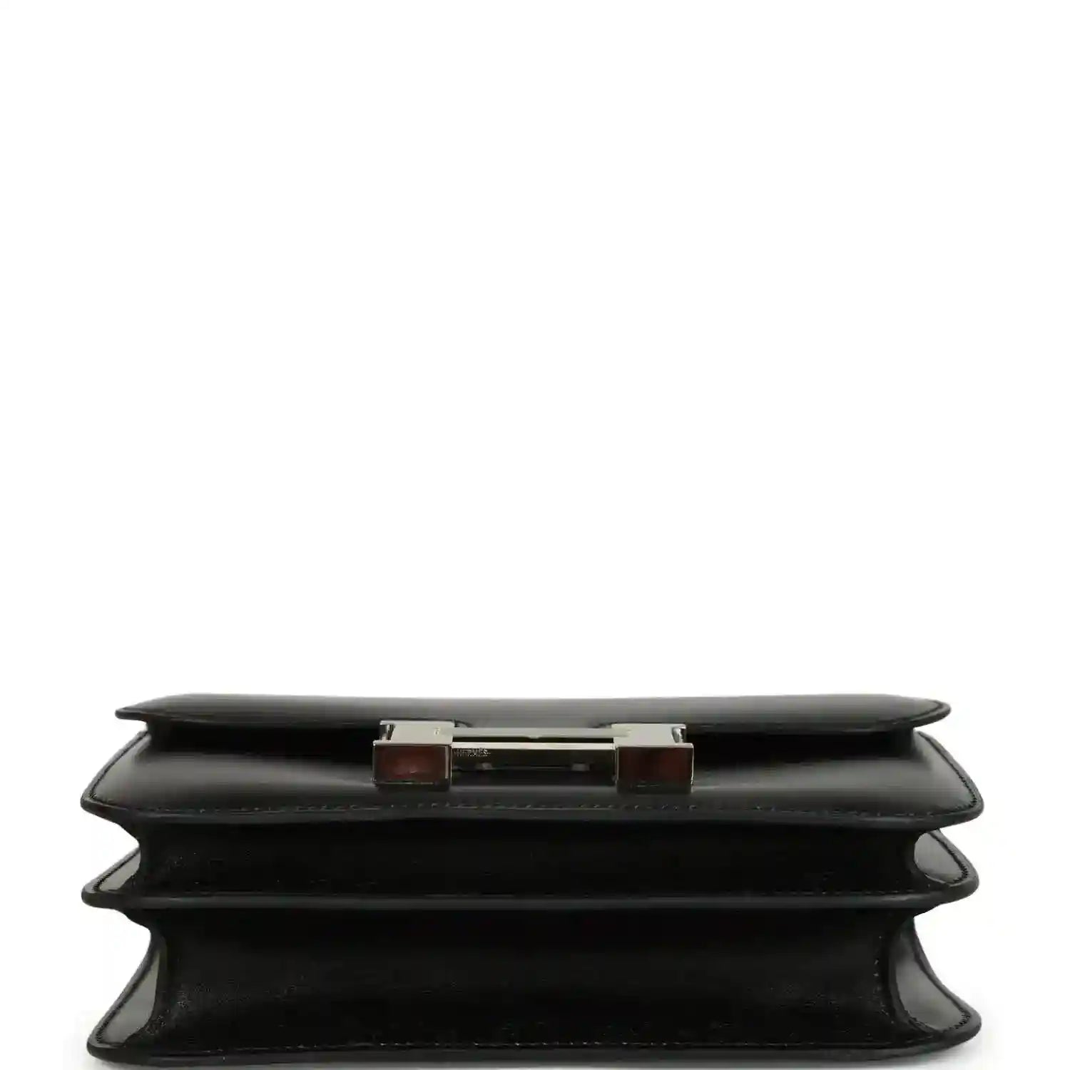 Black calfskin bag base view with layered feet and top edge hardware accents.