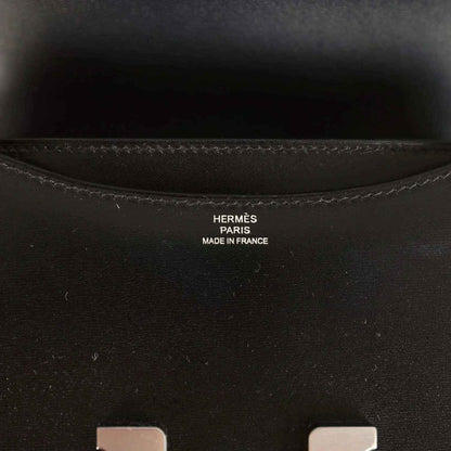 Hermes Paris made in France stamp inside black calfskin bag near seam stitching.