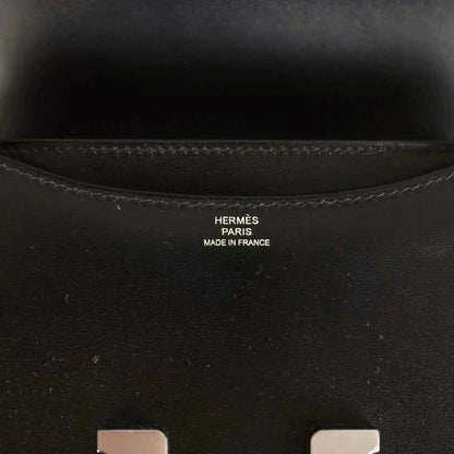 Hermes Paris made in France stamp inside black calfskin bag near seam stitching.