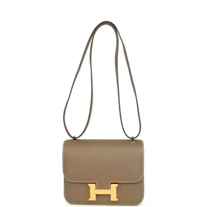 Etoupe Constance 18 crossbody bag with gold H clasp and long shoulder strap