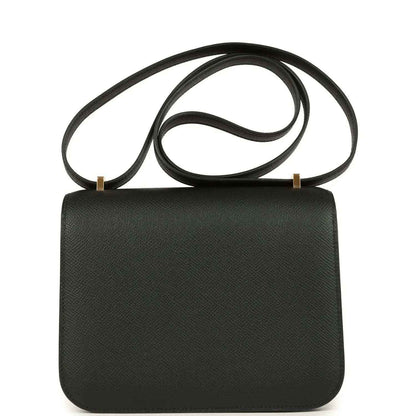 Black crossbody handbag with textured leather finish, top flap and shoulder strap.