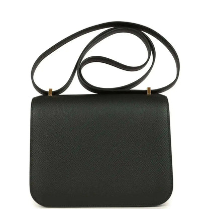 Black crossbody handbag with textured leather finish, top flap and shoulder strap.