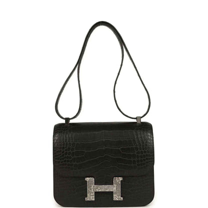 Black crocodile-pattern flap bag with gold H clasp and crossbody strap
