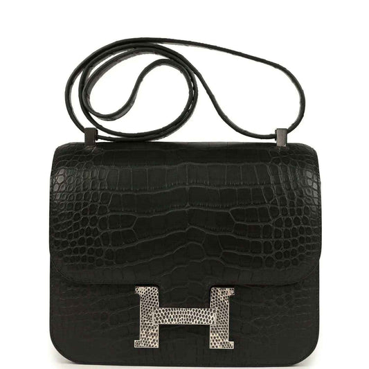 Black crocodile-pattern flap bag with gold H clasp and top handle