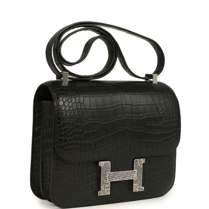 Black crocodile-pattern flap bag with gold H clasp and shoulder strap
