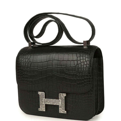 Black crocodile-pattern flap bag with gold H clasp and top handle